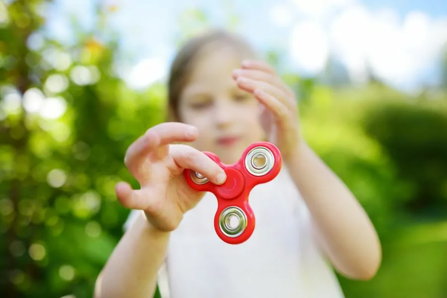 Young childwith fidget spinner