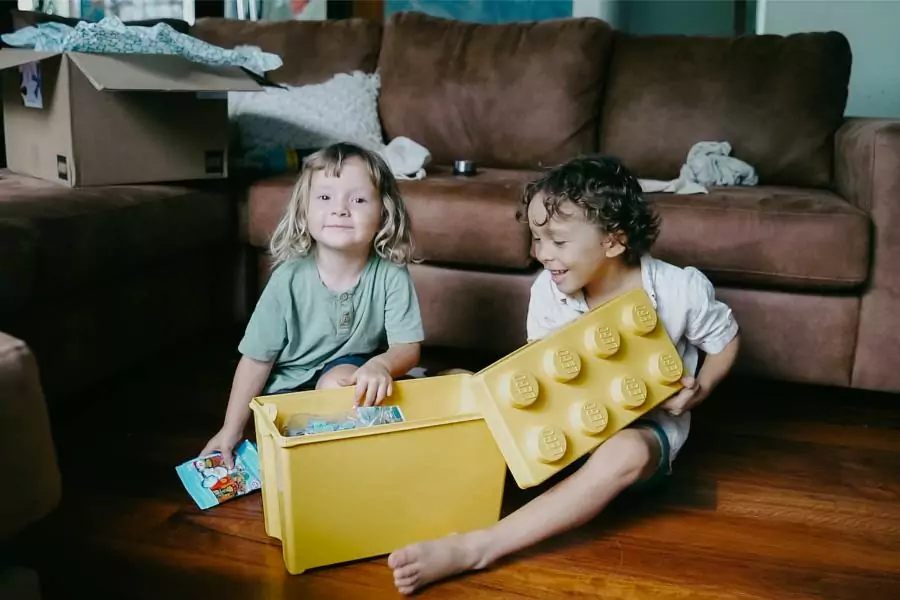 Two young children playing with lego